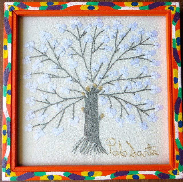 This embroidery captures the joyful essence of the Palo Santo. Alicia Sánchez de Cano, of Alamos, Sonora, is the embroiderer. Her husband, Hilario Cano, made the frame. 