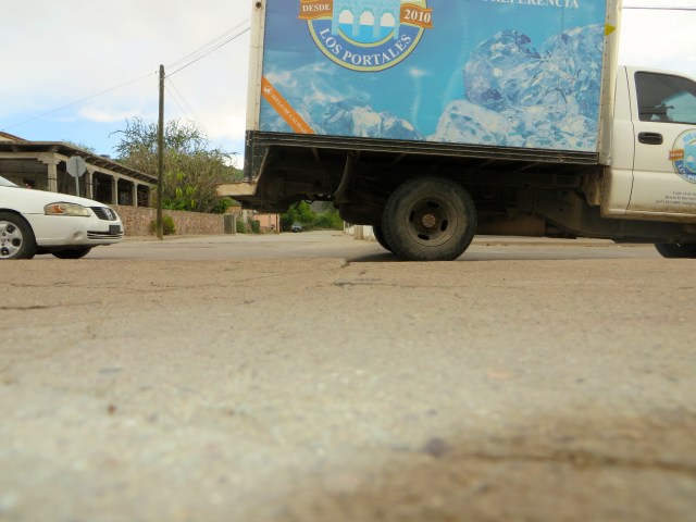 A truck passing over a tope on the verge of the school in our neighborhood, Escuela Primaría Revolución.
